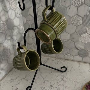 Retro vintage or antique ceramic stacking mugs in green glaze